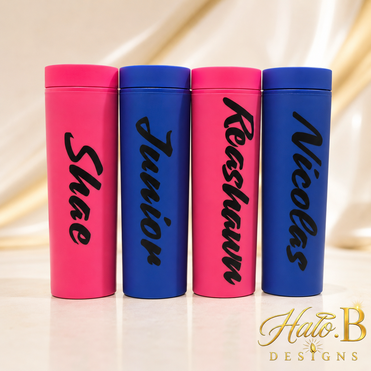 Four personalized name tumblers displayed together