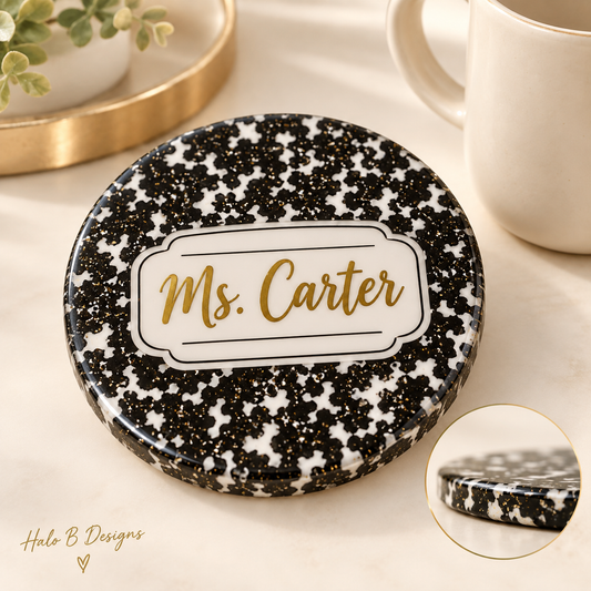 Personalized black and white composition-style teacher coaster with gold Ms. Carter name and resin edge detail